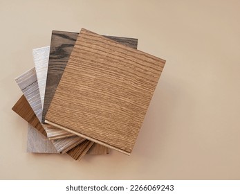 Engineered hardwood or laminate flooring swatch samples in various type of wood texture, isolated on beige background. A variety of shades of wood floor material.  - Shutterstock ID 2266069243