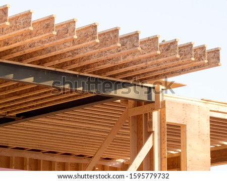 engineered wood joists on a steel beam in a house under construction