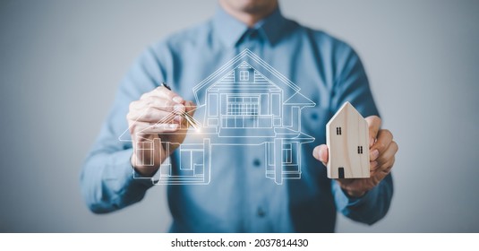 engineering and architecture drawings concept, Engineer man hold house on virtual screen of architect ,Insurance agent with model of house on light background,Property insurance and security concept. 