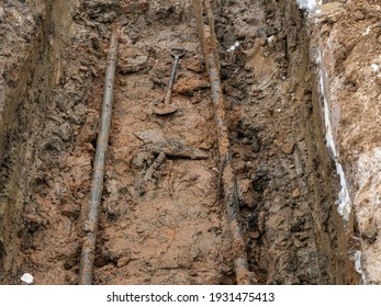 The Engineering Communications Of Power Supply Were Excavated. A Deep Pit With Thick Electrical Wires At The Bottom