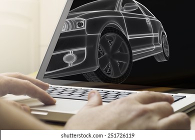 engineering concept: man using a laptop to design a car