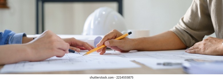 Engineering Construction Concept, Two Female Engineers Brainstorming Blueprint Of Project Together.