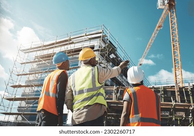 Engineering, construction site and team outdoor for building project, planning and architecture. Black woman and men contractor together for development and safety assessment discussion in city - Shutterstock ID 2302260717