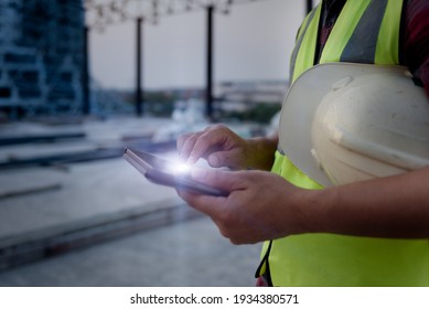 Engineering Consulting People On Construction Site Holding Tablet In His Hand. Management In Business Workflow And Building Inspector With BIM Technology In Construction Project.