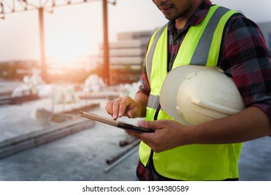 Engineering Consulting People On Construction Site Holding Tablet In His Hand. Management In Business Workflow And Building Inspector With BIM Technology In Construction Project.