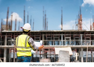 Engineering Consulting People On Construction Site Holding Blueprint In His Hand. Building  Inspector. Construction Site Check Drawing And Business Workflow Of New Building