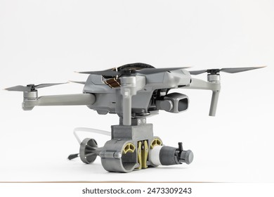 Engineering development for war, army drone with mechanism for dropping grenades on white isolated background. Concept military UAVs using in weapon.