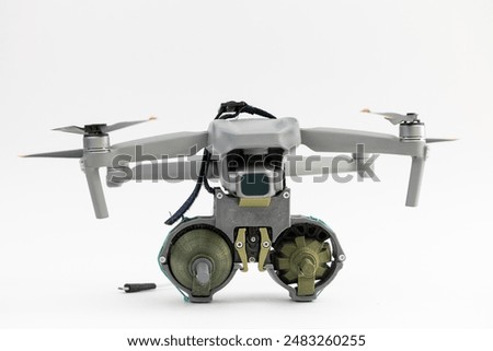 Engineering development for war, army drone with mechanism for dropping grenades on white isolated background. Concept military UAVs using in weapon.