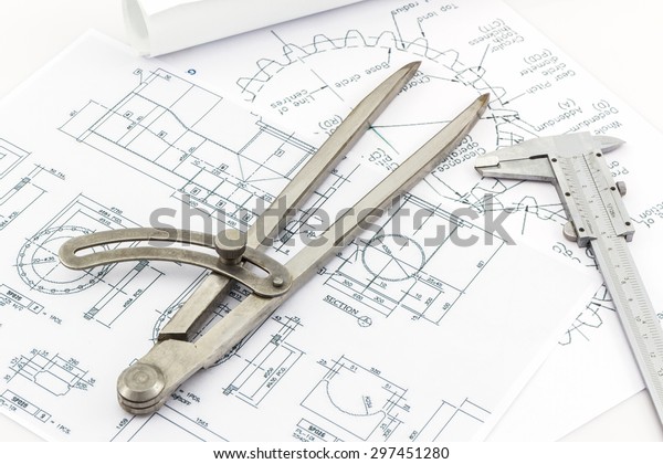 Engineering dividers Tools and\
Vernier scale on blueprint background, Construction\
concept..