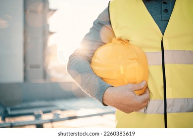 Engineering, helmet and hands of construction worker in lens flare for urban development and architecture mission. Building contractor, builder person or technician with safety gear on city rooftop