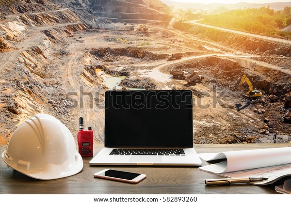 Engineering\
Industry concept, workspace of engineer on opencast mining quarry\
with lots of machinery at work This area has been mined for copper,\
silver, gold, and other minerals\
background