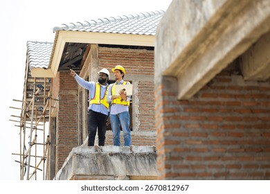 Engineering inspect construction site : construction worker Architects and contractor working together inside building under construction site. Engineering in safety harthat helmet. Engineering team