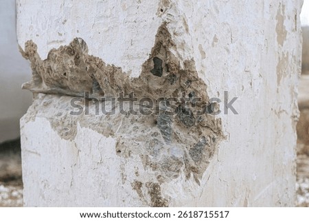 Engineering inspection of structures using destructive methods. Damaged concrete construction with exposed steel reinforced rods.
