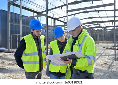 Engineering Instructor Working On Building Site With Apprentice