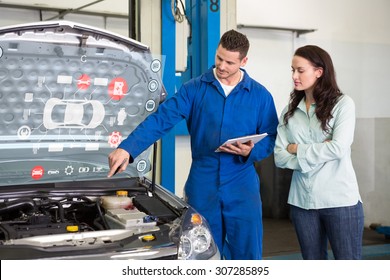 Engineering interface against mechanic showing customer the problem with car