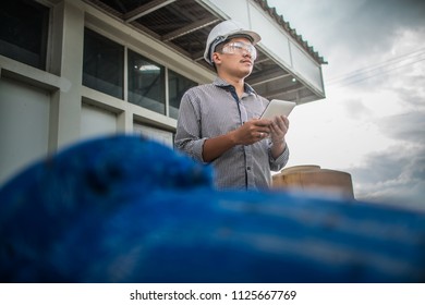 Engineering Man Construction And Checking Development Of A Small Business Hall. Reliable Civil Engineer Working On A Construction Site, Foreman At Work