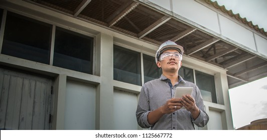 Engineering Man Construction And Checking Development Of A Small Business Hall. Reliable Civil Engineer Working On A Construction Site, Foreman At Work