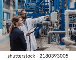 Engineering managers with tablet doing routine check up in industrial factory