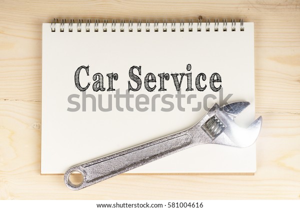 Engineering and mechanical concept. Car Service\
words on notebook with\
wrench.