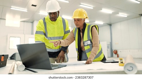 Engineering people, teamwork and laptop for construction site planning, floor plan and building design in warehouse. Industry man and senior woman with computer for architecture or blueprint solution - Powered by Shutterstock