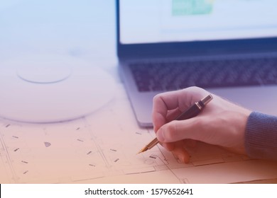 Engineering Process. Man Developing A Network Diagram For Wifi Access In Cafe. Access Point, Floor Layout, Laptop And Man Hand On The Bright Background. Space For Your Text.