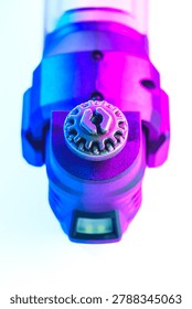 Engineering Series : Close up of an oscillating tool free blade change mechanism under high contrast vibrant lighting. This industrial design showcases mechanical evolution, precision engineering and the abstract beauty of human ingenuity in power tools.