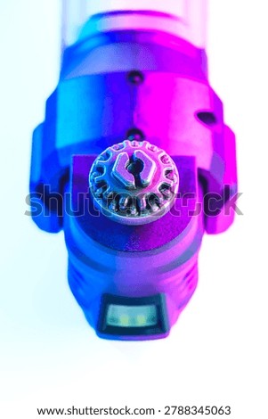 Engineering Series : Close up of an oscillating tool free blade change mechanism under high contrast vibrant lighting. This industrial design showcases mechanical evolution, precision engineering and the abstract beauty of human ingenuity in power tools.