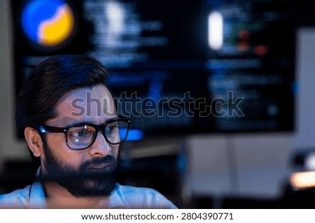 Engineering specialist evaluating AI model inference performance against real time code logs on a collaborative high resolution display.