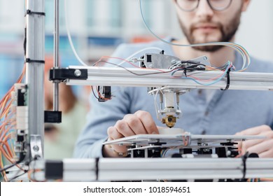 Engineering Student Using A 3D Printer In The Lab And Printing A Prototype