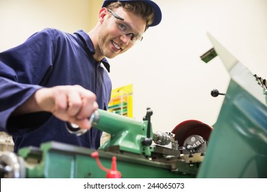 Engineering Student Using Heavy Machinery At The University