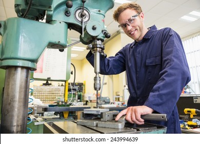 Engineering Student Using Large Drill At The University