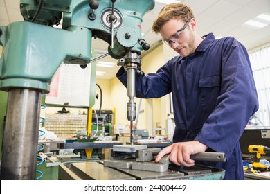 Engineering Student Using Large Drill At The University