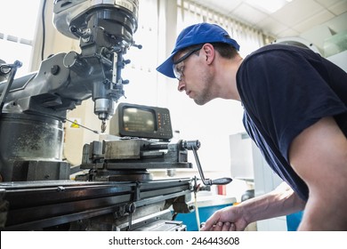 Engineering Student Using Large Drill At The University