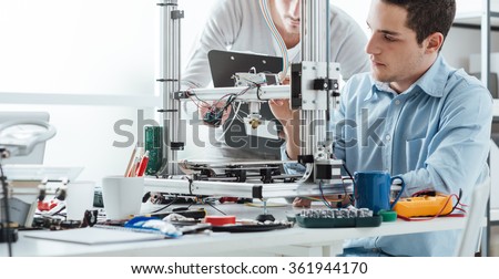 Engineering students using an innovative 3D printer in the laboratory