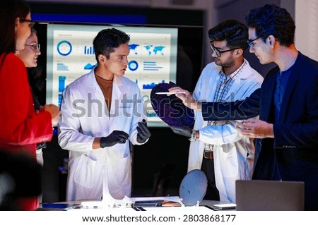 Engineering team collaborating in a cleanroom to implement advanced lithography precision, boosting wafer yield and chip manufacturing capacity through integrated automation technologies.