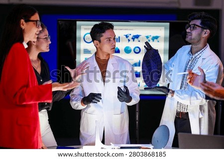 Engineering team collaborating in a cleanroom to implement advanced lithography precision, boosting wafer yield and chip manufacturing capacity through integrated automation technologies.