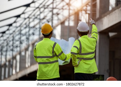 Engineering Team Engineering Consultants People At Construction Sites Hold Blueprints In Their Hands. Building Inspector. Check The Construction Site Drawing And Business Procedures Of The Building.