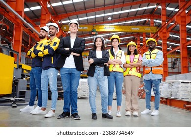 The engineering team and employees are happy to wear safety helmets. Smiling, happy working in the factory. - Powered by Shutterstock