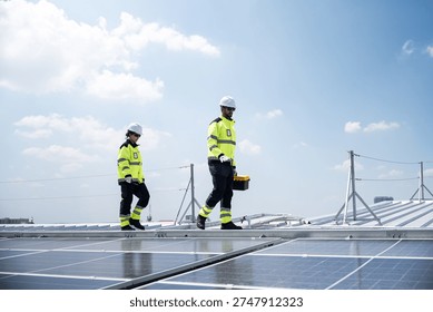 Engineering team installing and servicing rooftop solar panels at a large scale industrial facility, supporting sustainable electricity production and corporate clean energy strategy.