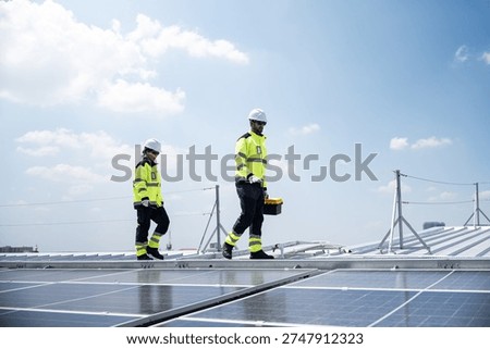 Engineering team installing and servicing rooftop solar panels at a large scale industrial facility, supporting sustainable electricity production and corporate clean energy strategy.