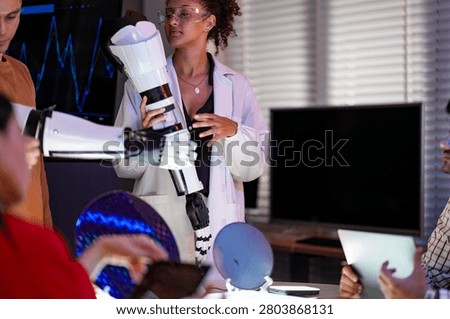 Engineering team integrating high-performance 2nm AI chipsets into robotic limb assemblies to achieve revolutionary precision and manufacturing scale-up.