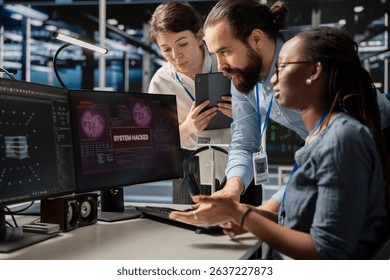 Engineering team in server room viewing security breach alert of zero day exploit vulnerability. Cybersecurity coworkers collaborating to trace intrusion origin and apply emergency patches