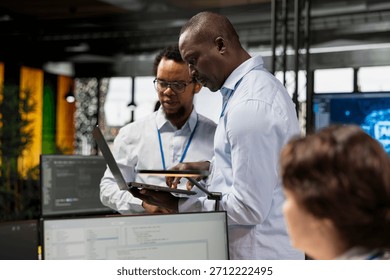 Engineering team testing AI machine learning algorithms at work using laptop. IT professionals scaling productivity with artificial intelligence large language model technology