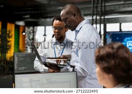 Engineering team testing AI machine learning algorithms at work using laptop. IT professionals scaling productivity with artificial intelligence large language model technology