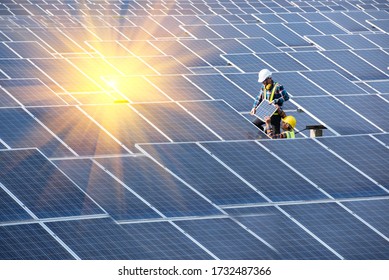 Engineering team working on solar photovoltaic solar cells to install new solar panels at industrial plants. - Shutterstock ID 1732487366
