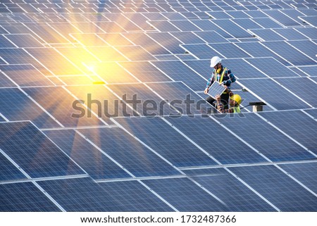 Engineering team working on solar photovoltaic solar cells to install new solar panels at industrial plants.