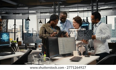 Engineering team working together in office, using specialized hardware to accelerate complex AI calculations. Coworkers cooperating, managing systems for machine learning training datasets, camera A