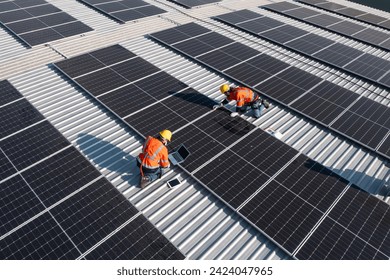 Engineering technician professional trained in skills and techniques installing solar photovoltaic panels system, engineer service check installation solar cell on factory roof, technology solar cell - Powered by Shutterstock