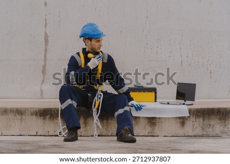 Engineering technicians are working to check the operation of wind turbines in a wind farm and check the electricity.(PHOTO)