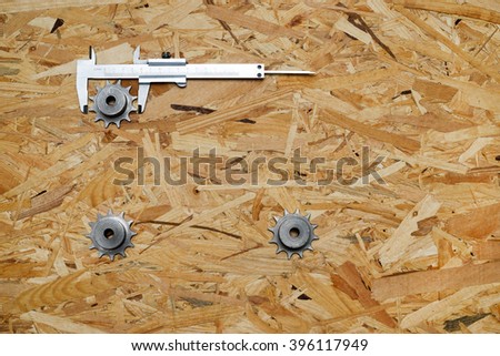 Engineering tools - gears and caliper on wooden table. Success concept. Top view Copy space for text. 